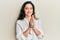 Beautiful hispanic woman playing with catholic rosary smiling with a happy and cool smile on face