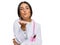 Beautiful hispanic woman wearing doctor uniform and stethoscope looking at the camera blowing a kiss with hand on air being lovely