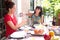 Beautiful hispanic women enjoying an outdoor home meal together