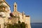Beautiful historic tower in Rab, with sea in background