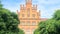 Beautiful historical building of Chernivtsi national university religious seminary of red brick facade with green trees