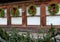 Beautiful holiday wreaths and fir branches on wood building