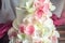 Beautiful home wedding four-tiered cake decorated with pink and green fondant handmade