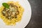 Beautiful homemade pasta with meat sauce and gorgonzola cheese on black stone background