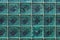 A beautiful horizontal texture of part of a glass transparent square brick wall in green hue