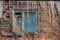 A beautiful horizontal texture of part of an old crashed brick wall in orange hue with an old window with a pigeon and a group of