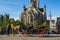 Beautiful horse carriage with the facade of Saint Nicholas` Church Sint-Niklaaskerk and the clock tower of Former Post Office a