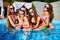 Beautiful hot pretty girls in bikini are swimming in a pool on an inflatable watermelonswim ring floaty. Attractive slim