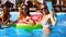 Beautiful hot pretty girls in bikini taking selfie in swimming pool on inflatable watermelon floaty. Fitted women in