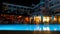 Beautiful hotel illuminated at night near the blue pool.