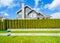 Beautiful house behind a green hedge fence