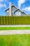 Beautiful house behind a green hedge fence