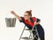 Beautiful house painter on a stepladder on a white background