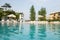 Beautiful house, swimming pool view from the veranda, summer day (Focus on pool water)..