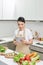Beautiful housewife lady hold digital tablet searching recipe internet lecture master class cook delicious family dinner