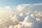 Beautiful huge cumulus white clouds from airplane height in bright sunny weather