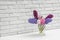 Beautiful hyacinths in glass vase on table against brick wall, space for text