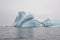 Beautiful iceberg with a Zodiac boat in the far distance