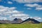 Beautiful Icelandic landscape with volcano, mountains, sky and clouds.