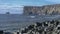 Beautiful icelandic seacoast with cliffs and blue clear cloudy sky