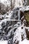 Beautiful icy waterfall in the forest. Vosges mountains.