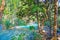 Beautiful idyllic lonely tropical waterfall staircase cascade, turquoise blue secluded water plunge pool, green forest jungle -