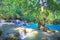 Beautiful idyllic lonely tropical waterfall staircase cascade, turquoise blue secluded water plunge pool, green forest jungle -