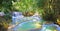 Beautiful idyllic lonely tropical waterfall staircase cascade, turquoise blue secluded water plunge pools, green forest jungle -