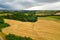 Beautiful idyllic summer or autumn landscape of Toscana with hills, forest trees and agricultural fields.