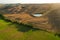 Beautiful idyllic summer landscape of Toscana with many mediterranean plants, hills, fields and pond.