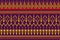 Beautiful Ikat Paisley pattern on a purple background. Yellow and red