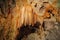 Beautiful illuminated cave formations and stalactites inside of the St. Michaels cave in Gibraltar, Upper Rock Natural Reserve,