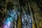 Beautiful illuminated limestone stalactites in Adygeya underground cave, speleology grotto