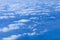 Beautiful image above the white clouds. Blue sky and white clouds taken from aeroplane. Nature sky background concept.