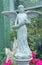 Beautiful image of an angel sculpture holding bouquet of flowers