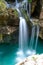 Beautiful image of blurred stream of waterfalls falling over mossy rocks