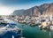 Beautiful image of harbor with moored motorboats and yacht at Los Gigantes, Tenerife island