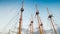 Beautiful image of high mast of historical wooden ships and boats against blue sky