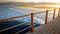 Beautiful image of long wooden pier in the ea. Amazing sunset over the bridge in ocean