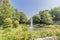 Beautiful image of a park with a pond with a fountain