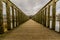 Beautiful image of a way on a wooden bridge leading to a gazebo in the middle of the lake