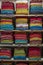 Beautiful Indian coloured cloth fabric folded on shelves for sale, India