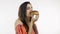 Beautiful Indian girl eating yummy chocolate donuts isolated over white background