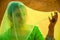 Beautiful Indian woman covers her face with a green cloth saree, woman in veil