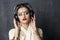 Beautiful Indian woman listening to music on headphones