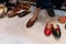 Beautiful Indian woman trying out her foot for fitting of colorful Rajsathani ladies shoes at shoe store at famous Sardar Market