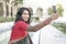 Beautiful Indian woman using camera phone to take a self portrait