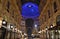 Beautiful inside panoramic view to the Vittorio Emanuele II Gallery with giant blue crest made of Swarovski crystals and cafes.