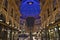 Beautiful inside panoramic view to the Vittorio Emanuele II Gallery with giant blue crest made of Swarovski crystals and cafes.