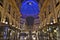 Beautiful inside panoramic view to the Vittorio Emanuele II Gallery with giant blue crest made of Swarovski crystals and cafes.